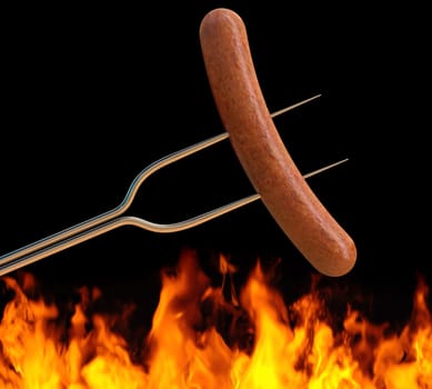hot dog on a long fork over a fire