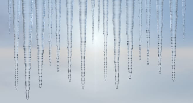 Icicles hanging outside against a hazy sky