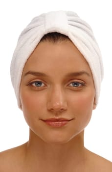 Head shot of a pretty young woman with a spa turban on a white background