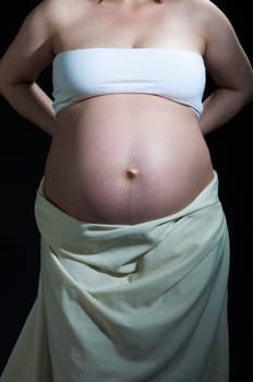 Cropped shot of baby belly in caucasian woman.