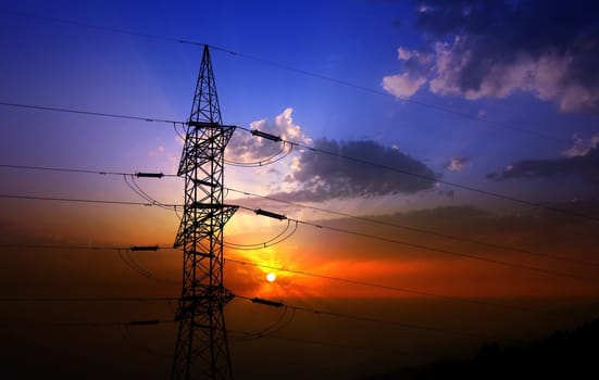 Dramatic clouds sky and electric tower backlight silhouette