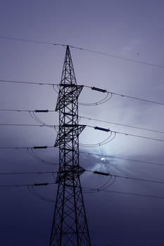 Dramatic clouds sky and electric tower backlight silhouette