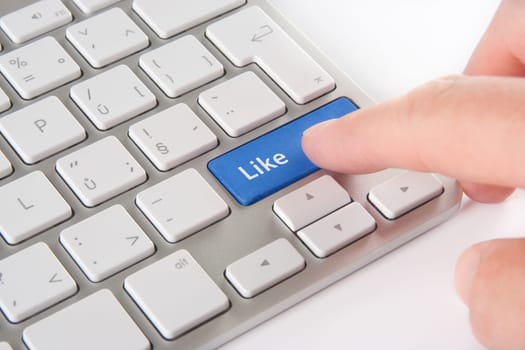 Like button on computer keyboard pressed by user - social network concept.