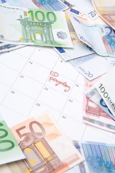Payday concept - calendar wit text payday and money.