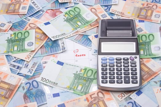 Calculator, money and calendar with taxes reminder.