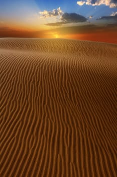 Desert dunes dramatic sunset in Maspalomas Oasis Gran Canaria at Canary islands