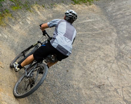 Mountain bikers in an inclined position on the downhill