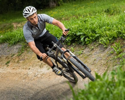 Mountain bikers in an inclined position on the downhill