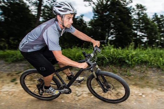 Mountain bikers in an inclined position on the downhill