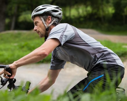 Mountain bikers in an inclined position on the downhill