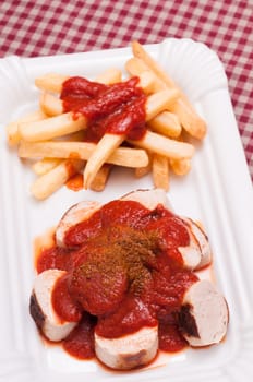 Currywurst with curry sauce and French fries