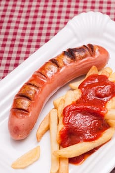 Red sausage and French fries with ketchup