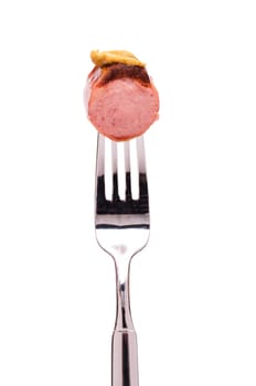 Red sausage with mustard on a fork