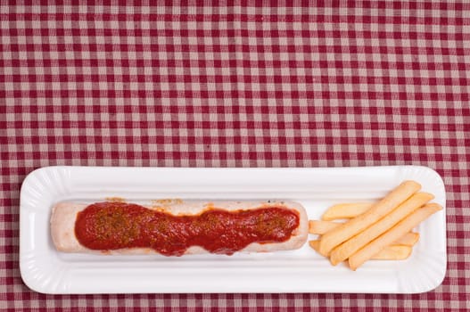 Currywurst with curry sauce and French fries and text space