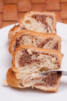Three pieces of nut cake on a white plate