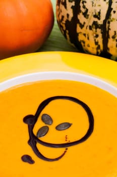 Pumpkin soup and pumpkins in the background