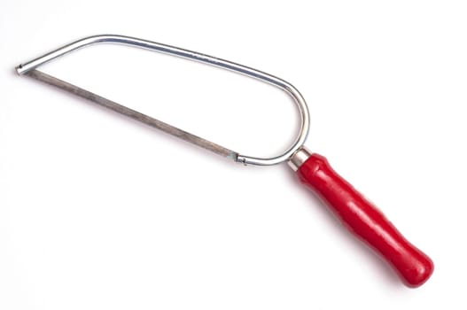 Small metal saw with red wooden handle