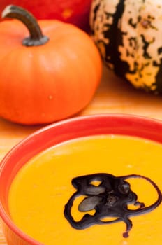 Pumpkin soup and several pumpkins in the background