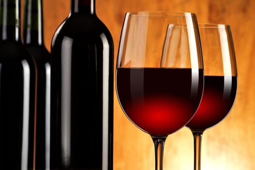 Composition with two wineglasses and bottles of red wine