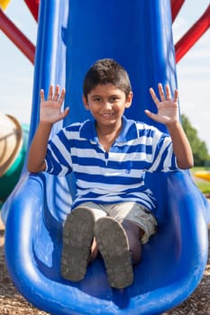 Outdoor portrait of a cute little indian boy at playground