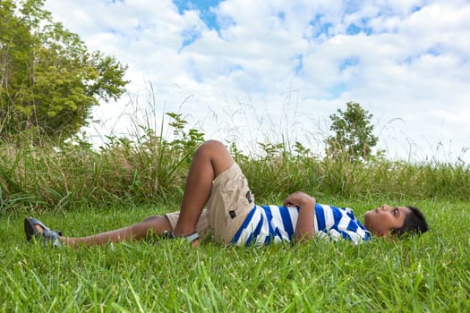 Outdoor portrait of a cute little indian boy looking to the sky