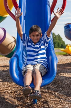 Outdoor portrait of a cute little indian boy at playground