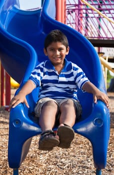 Outdoor portrait of a cute little indian boy at playground