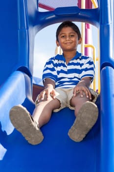 Outdoor portrait of a cute little indian boy at playground