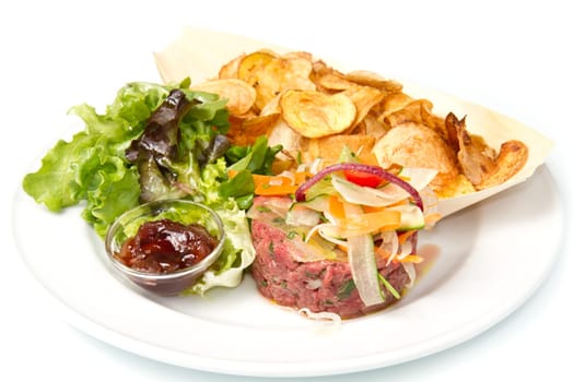 raw ground beef with chips and salad