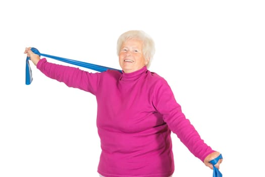 Happy senior lady doing exercises using a strap to extend and strenthen her neck and shoulder muscles and increase suppleness