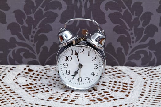 Nostalgic alarm clock on crochet blanket