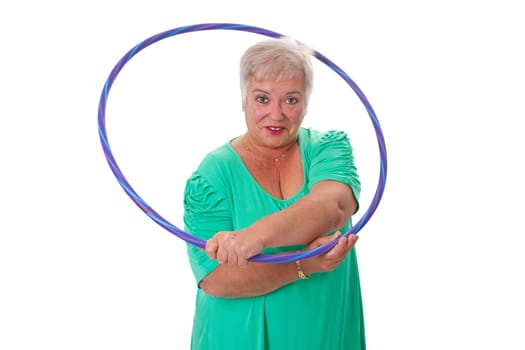 Senior woman with hula hoop doing workout - isolated on white background