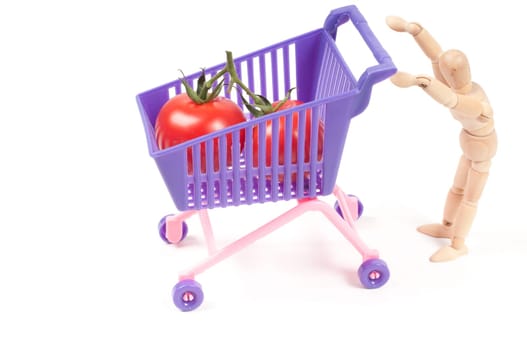 Conceptual photo with wooden man and shopping-cart isolated on white