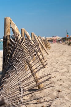 Wooden fence on the sandy beach, good weather