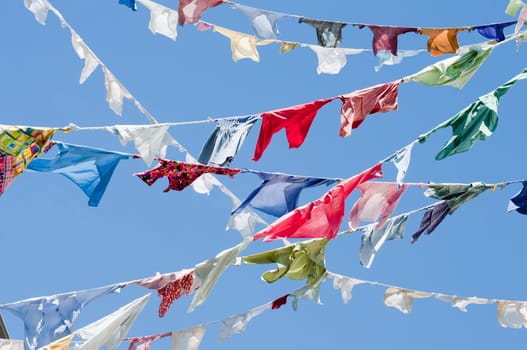 Colorful shirts hanging on a blue sky