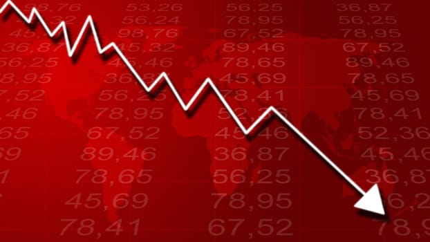 Arrow graph going down and electronic stock numbers on a blue background.