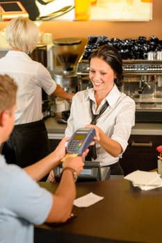 Man paying bill at cafe using card bill happy waitress