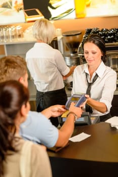 Man paying bill at cafe using card bill happy waitress