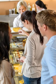 Customers waiting in line to buy dessert woman man cafe