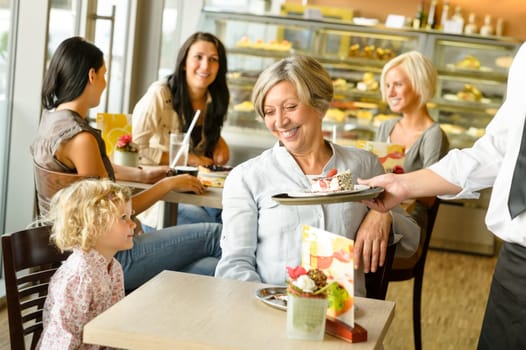 Grandmother and grandchild waiting cake order cafe dessert waiter plate