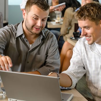 Men business partners working on laptop cafe restaurant