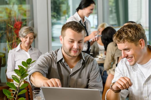 Men business partners working on laptop cafe restaurant