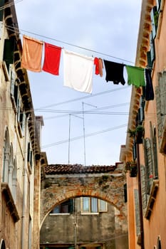 Fresh laundry hanging between two houses in venice