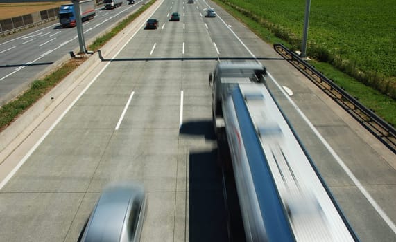 Truck and car in blurred motion on a highway