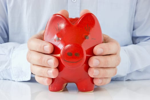 Business man holding piggy bank , concept for money protection