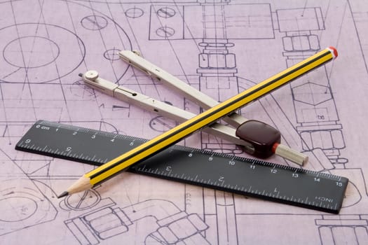 blueprint with pencil, ruler and dividers lying on it
