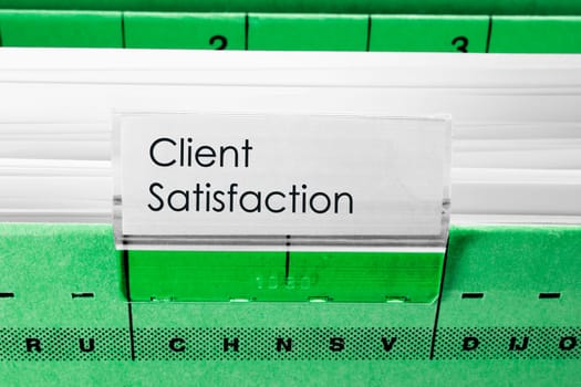green hanging file folder labeled with Client Satisfaction