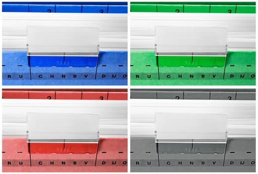 hanging file folders in blue, green, red and grey with blank labels
