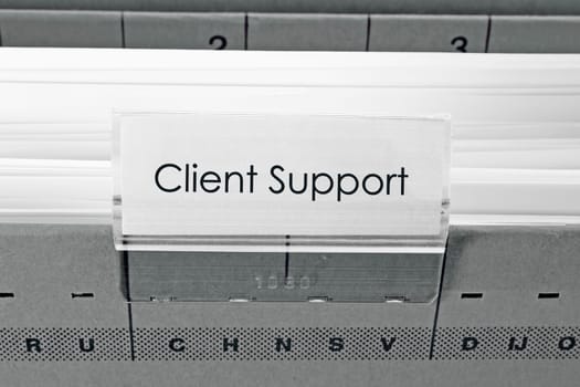 grey hanging file folder labeled with Client Support