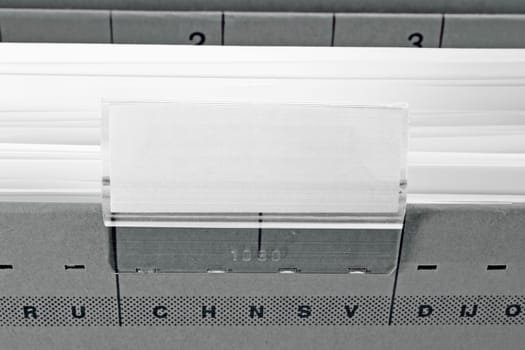 grey hanging file folder with blank label